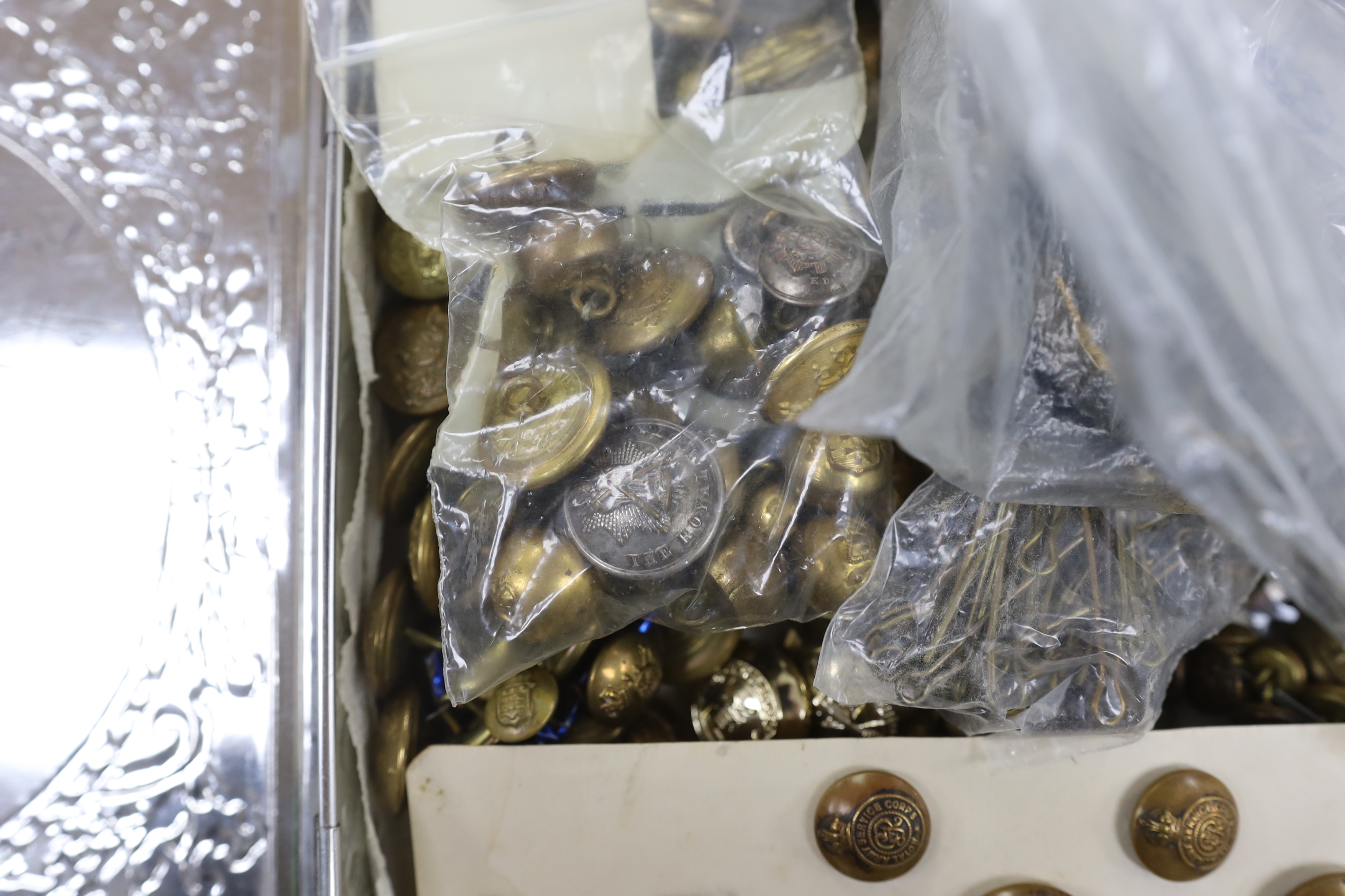 A collection of military buttons, examples including; Royal Fusiliers, Royal Navy, Royal Artillery, RASC, RAMC, RAF, etc. and a few cloth titles, etc.